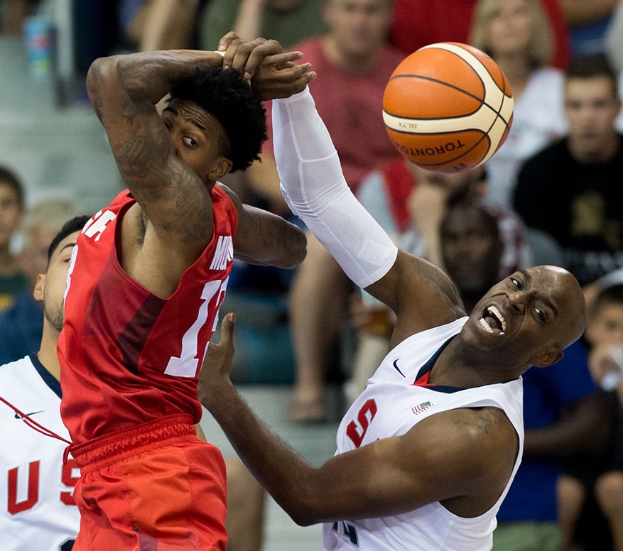 (left to right) Canadian Daniel Mullings and USA Damien Wilkins fight for the ball in a semi-final men’s basketball game as part of the Pan Am Games in Toronto.  Canada beat the United States 111-108 in overtime.
