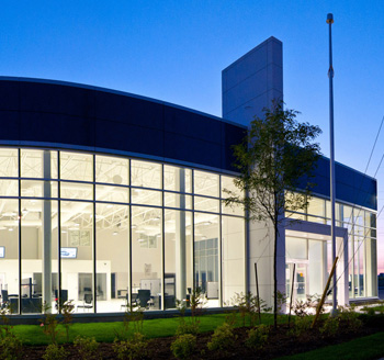 Photo of a large corporate office complex with bright lights and perfect landscape