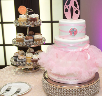 Cupcakes and a traditional cake on display at a family party celebration