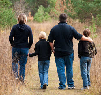 Parents and children go for an autumn walk in a park for a family photo