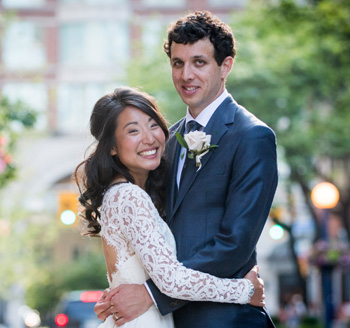 Couple pose for wedding photo in downtown venue