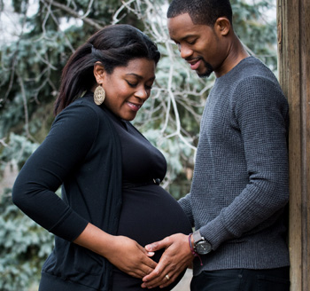 African american couple pose for a pregnancy photo during winter in Toronto