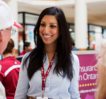 Event photo of a beautiful woman greeting people at a business conference in downtown Toronto