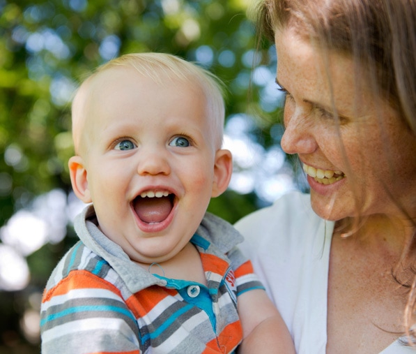 Small toddler flashes a big smile for the camera