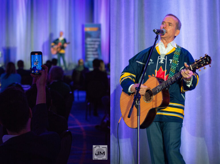 Chris Hadfield playing guitar at a conference in Toronto